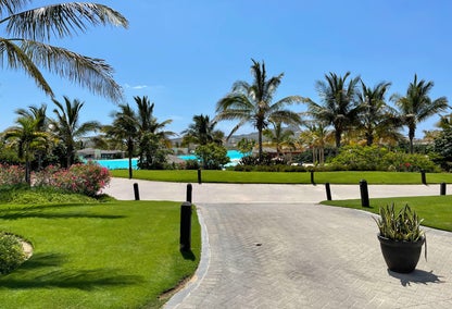 Palm trees around a pool at the golf community of Diamante in Los Cabos, Mexico